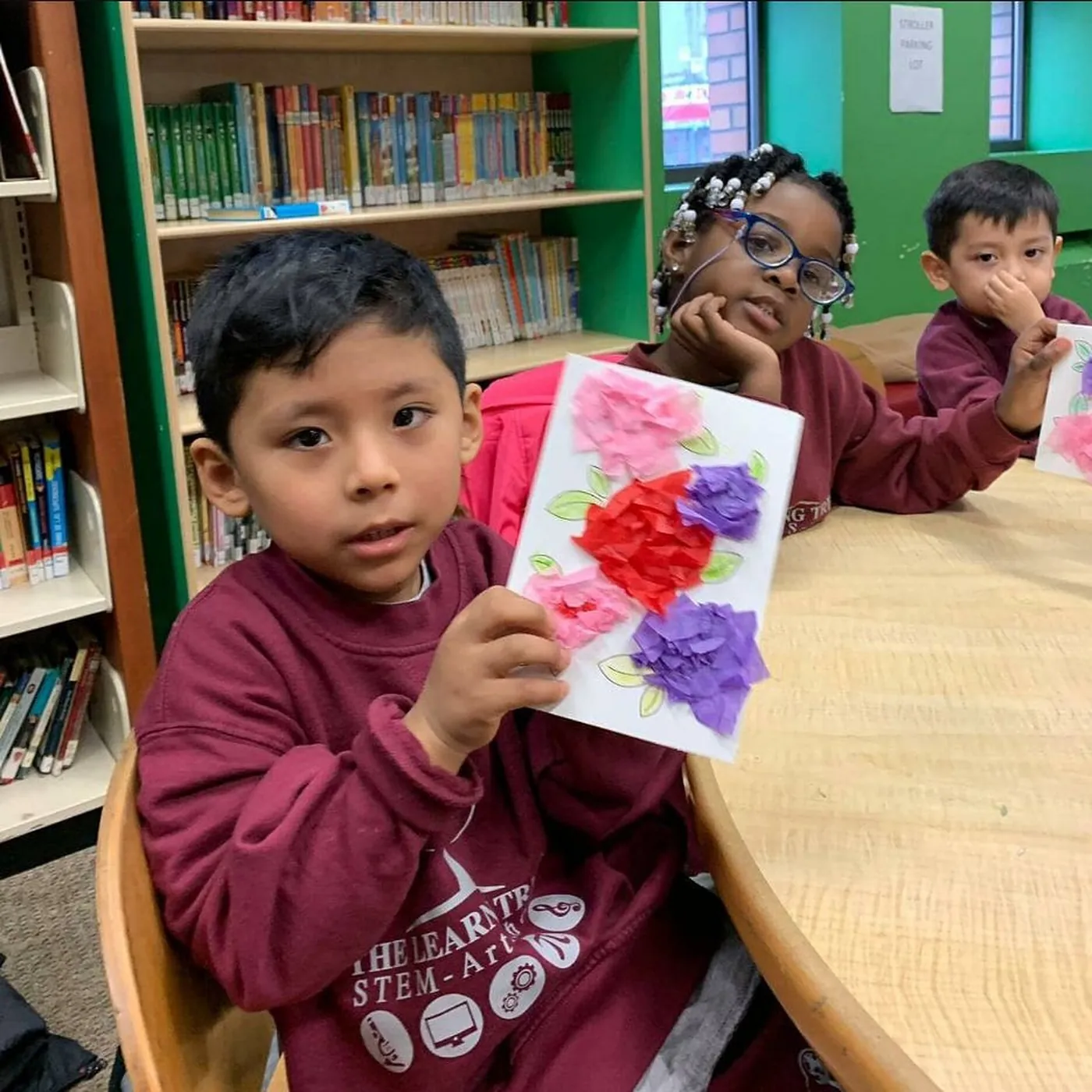 Students working together at a table in the school library